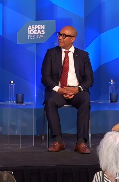 Two women and a man sit onstage at a panel at the Aspen Ideas Festival. 