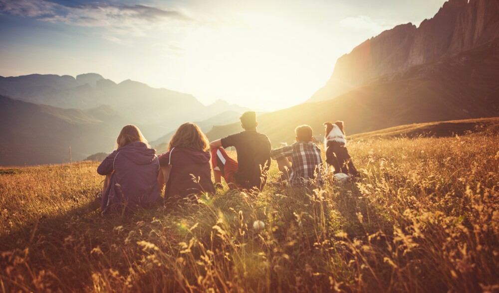 Adventures on the Dolomites: teens and dog enjoy a sunbath.