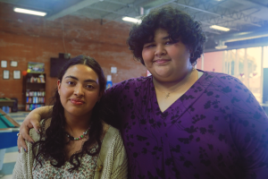 WeThrive students Cisa Salazer  and Chelsea Vasquez smile and embrace at the Hawthorne Teen Center in Hawthorne, California.