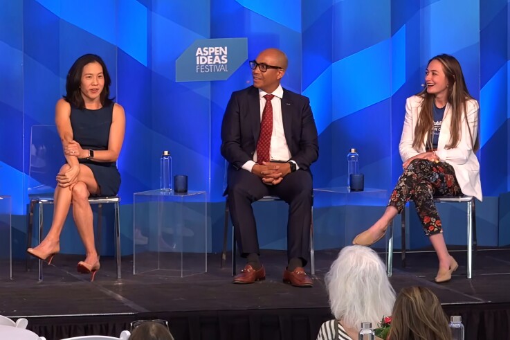 Two women and a man sit onstage at a panel at the Aspen Ideas Festival. 