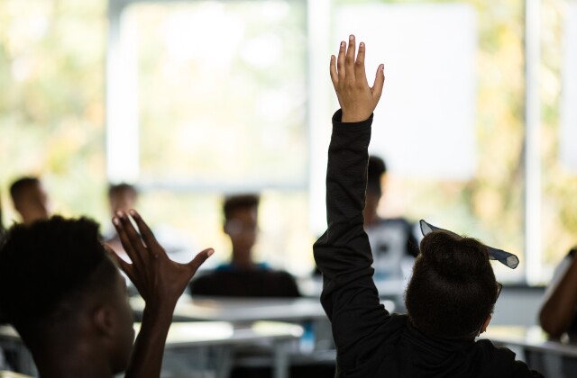 Education. Innovation. Girl Raising Hand