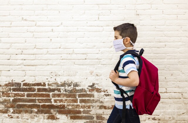 Male student wearing mask and backpack