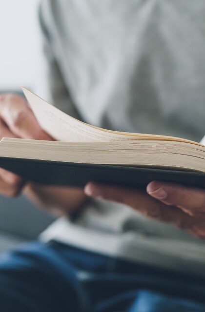 A student flips through the pages of a textbook.