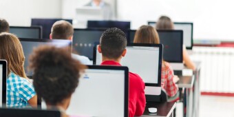 Rear view of group of people in a computer lab.