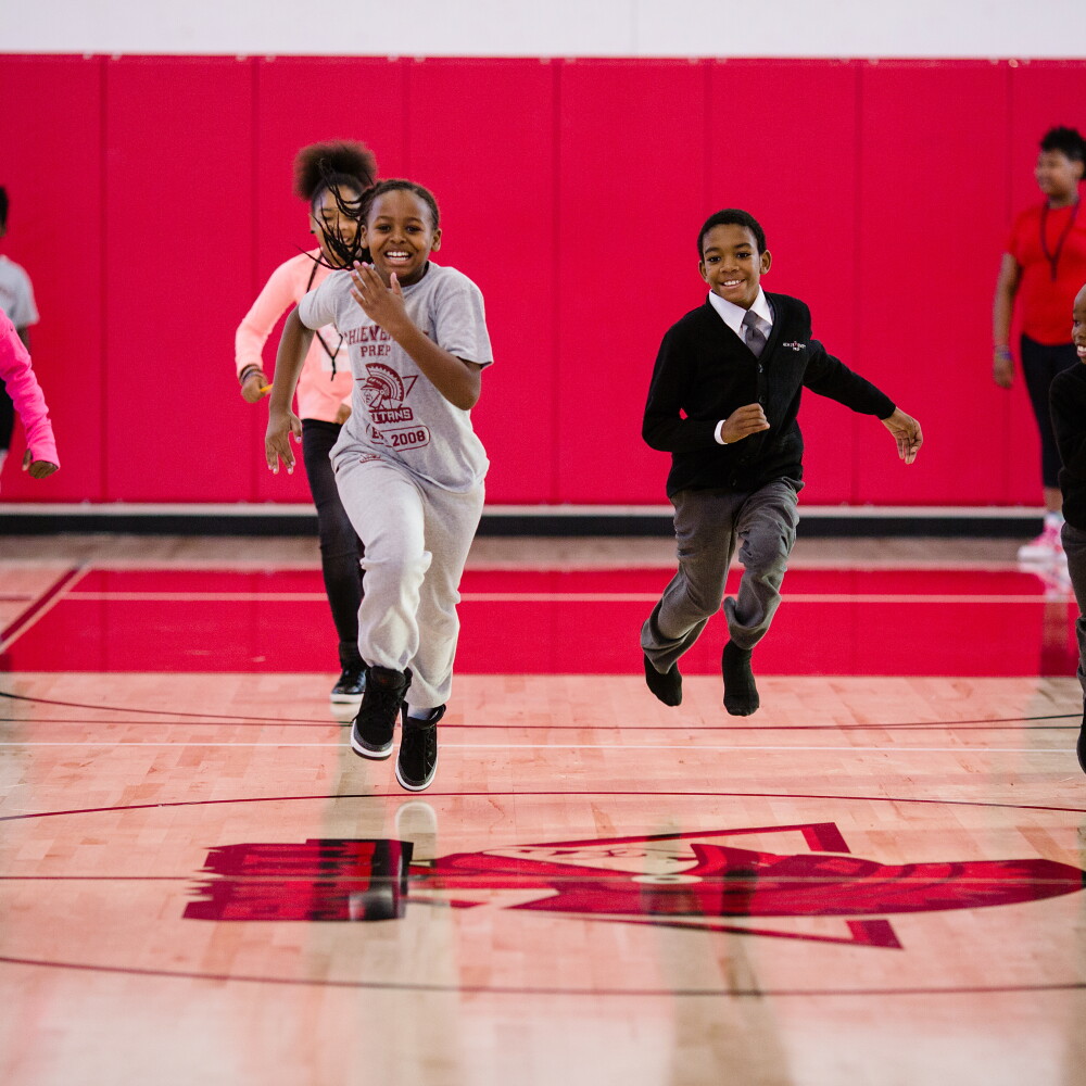 Students running in gymnasium