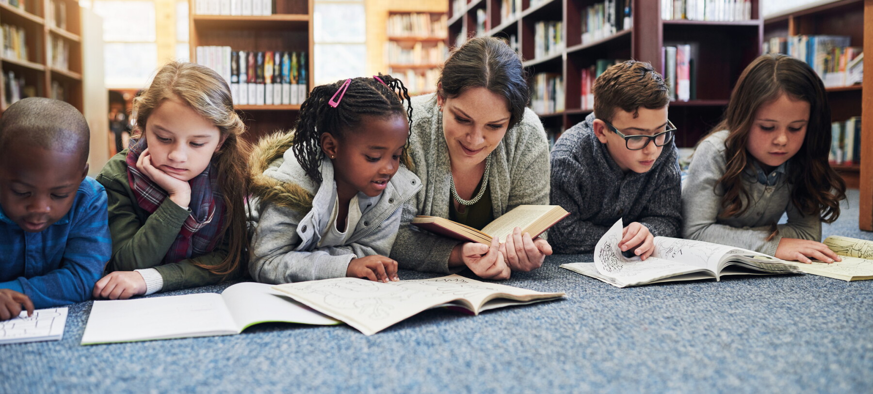 Students and teacher reading books