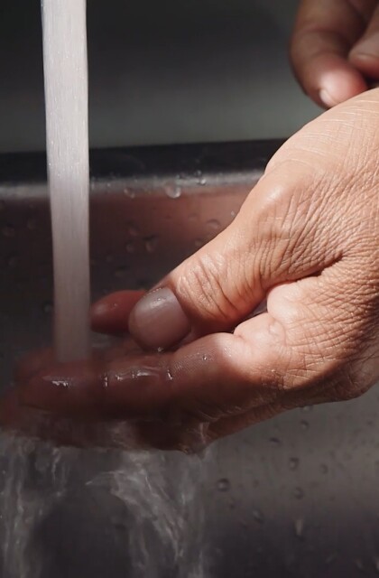 Navajo Water Project. Hand under tap