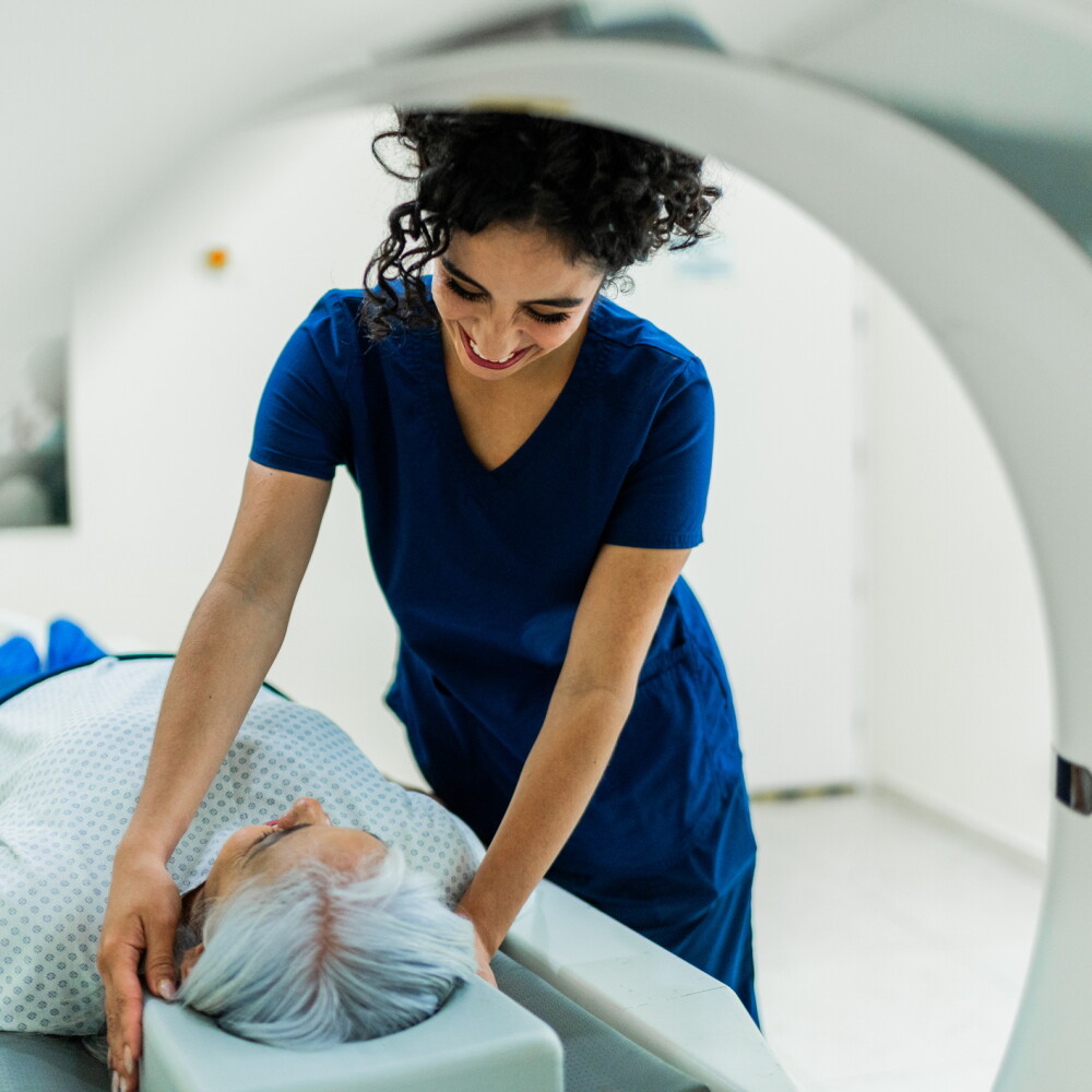A nurse assists a patient undergoing an MRI.
