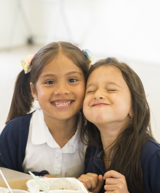 Two students smiling TLC Innovative Schools