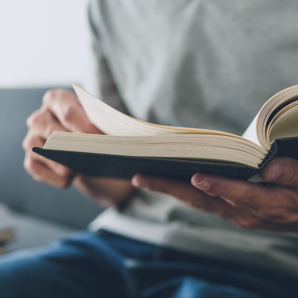 A student flips through the pages of a textbook.
