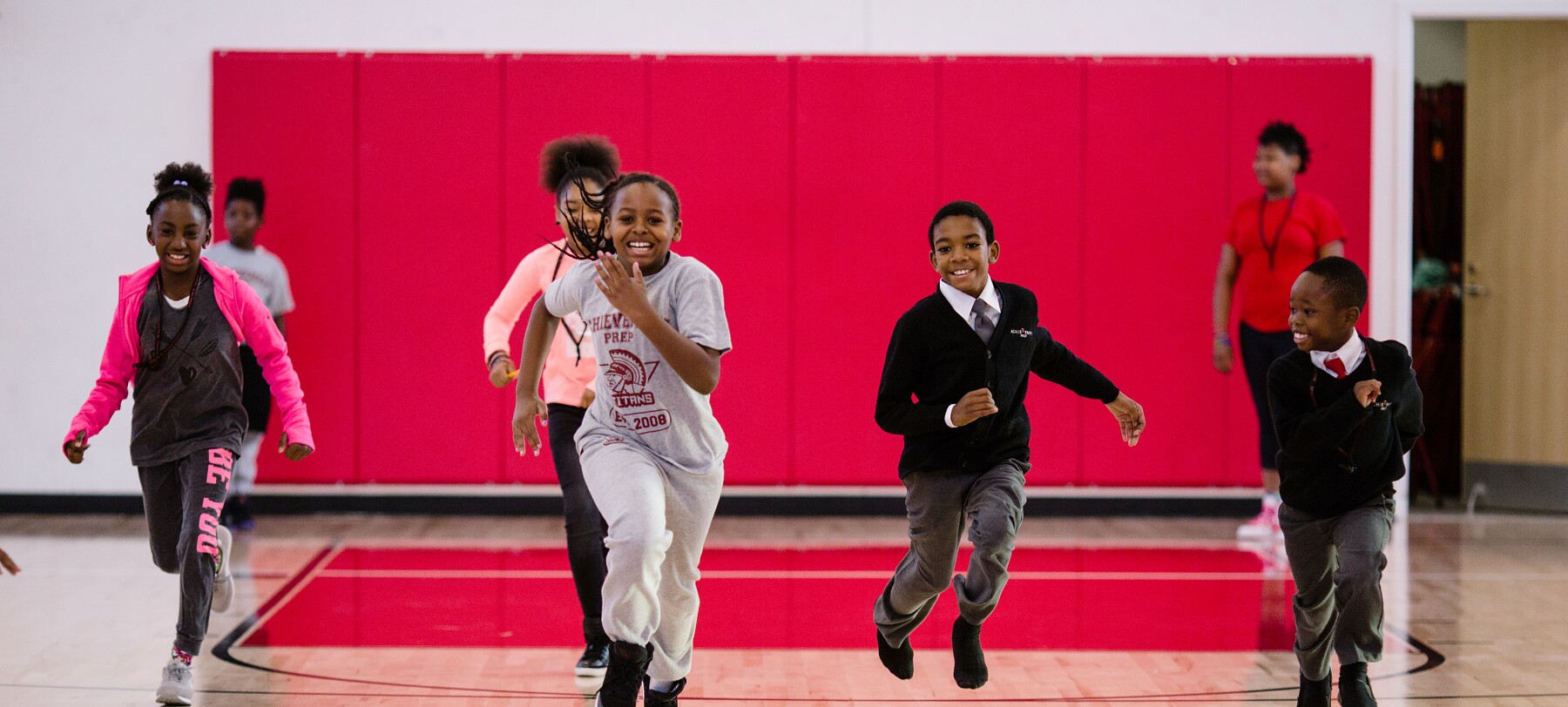 Students running in gymnasium