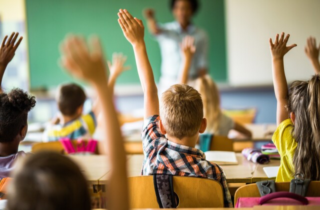 Classroom with Kids Hands Raised