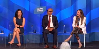 Two women and a man sit onstage at a panel at the Aspen Ideas Festival. 