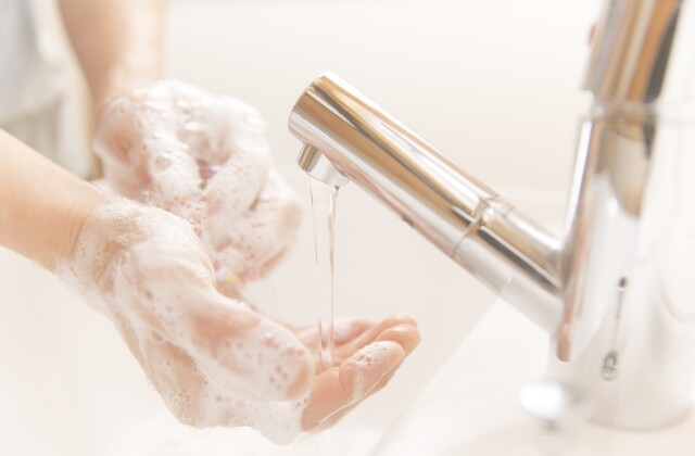 Running water faucet washing hands