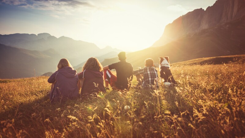 Adventures on the Dolomites: teens and dog enjoy a sunbath.