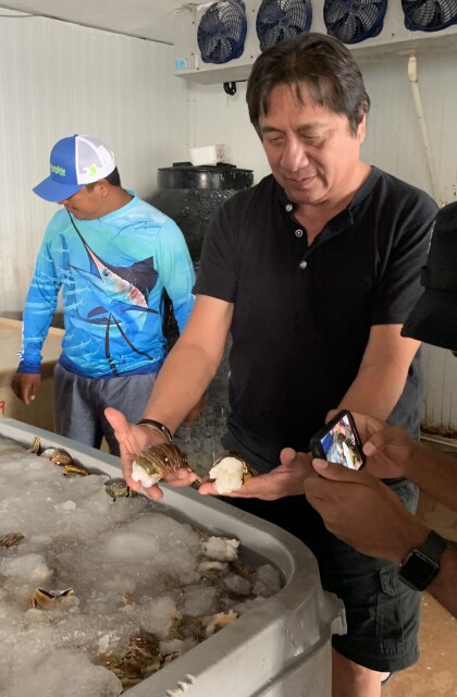 José Luis “Chino” Carrillo shows Walton Family Foundation intern Joshua Ventress some of the day's catch