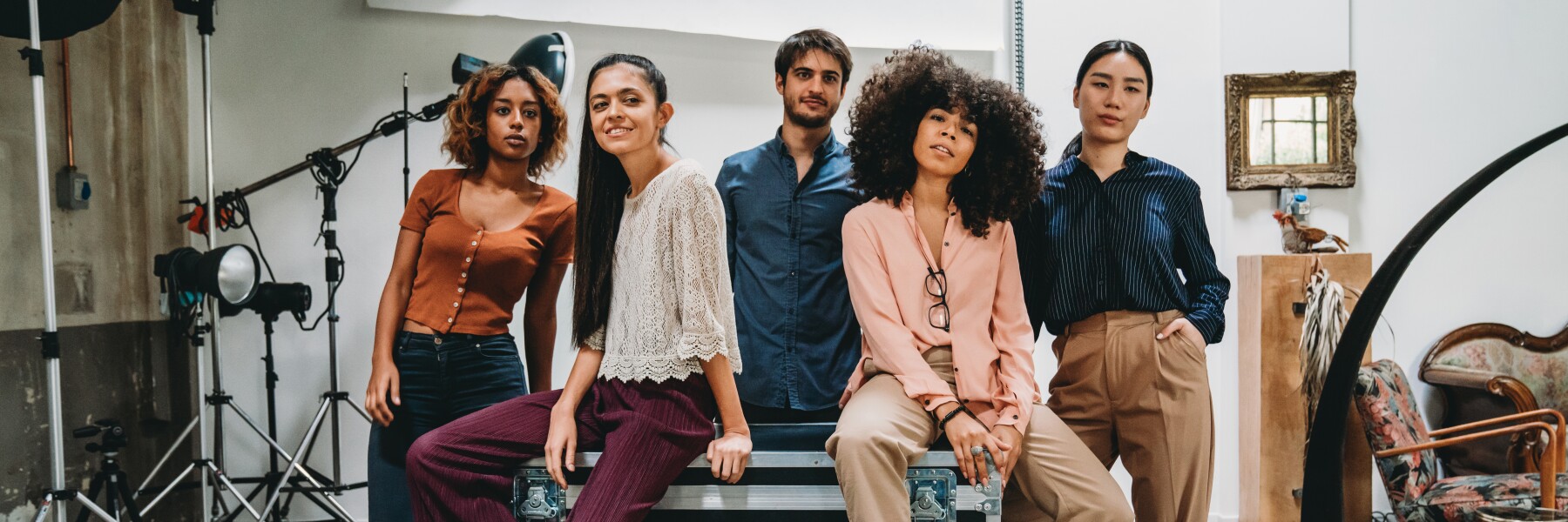 Portrait of a creative group of people in a modern loft with photographic equipment in the background