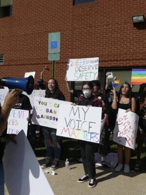 Student activists demonstrate outside a building.