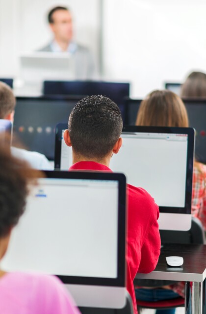 Rear view of group of people in a computer lab.