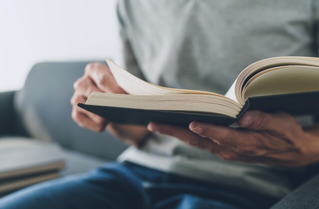 A student flips through the pages of a textbook.