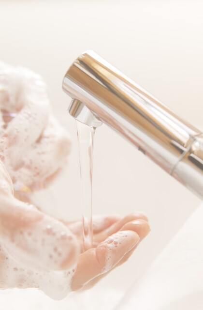 Running water faucet washing hands