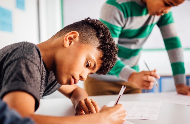 Students write in classroom