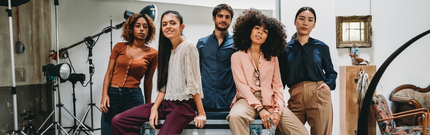 Portrait of a creative group of people in a modern loft with photographic equipment in the background