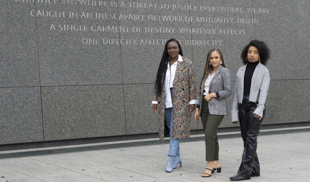Walton Family Foundation associates Wiselene Dorceus, Bre'Anna Brook and Alisha Torres pose for a photograph at the Martin Luther King Jr. Memorial in Washington, D.C. 