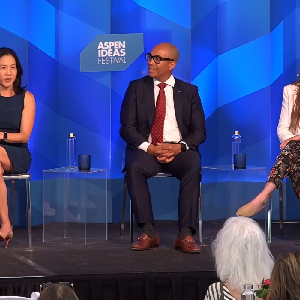 Two women and a man sit onstage at a panel at the Aspen Ideas Festival. 