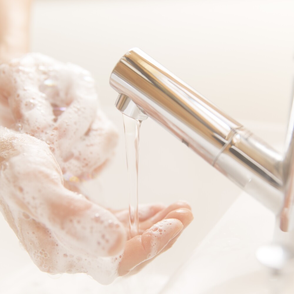 Running water faucet washing hands