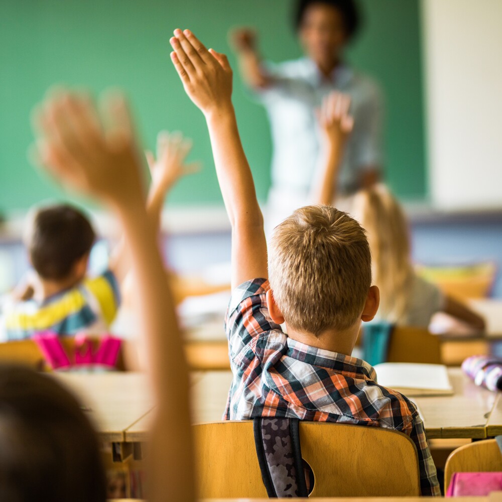 Classroom with Kids Hands Raised