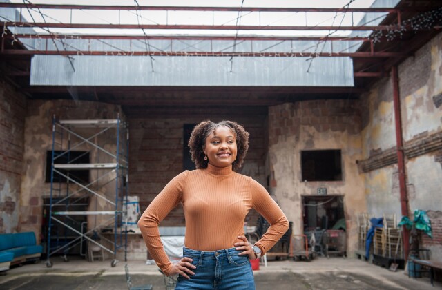 Aspen Young Leaders fellow Kaitlyn Done stands and smiles in front of the New Roxy Theater in Clarksdale, Miss.