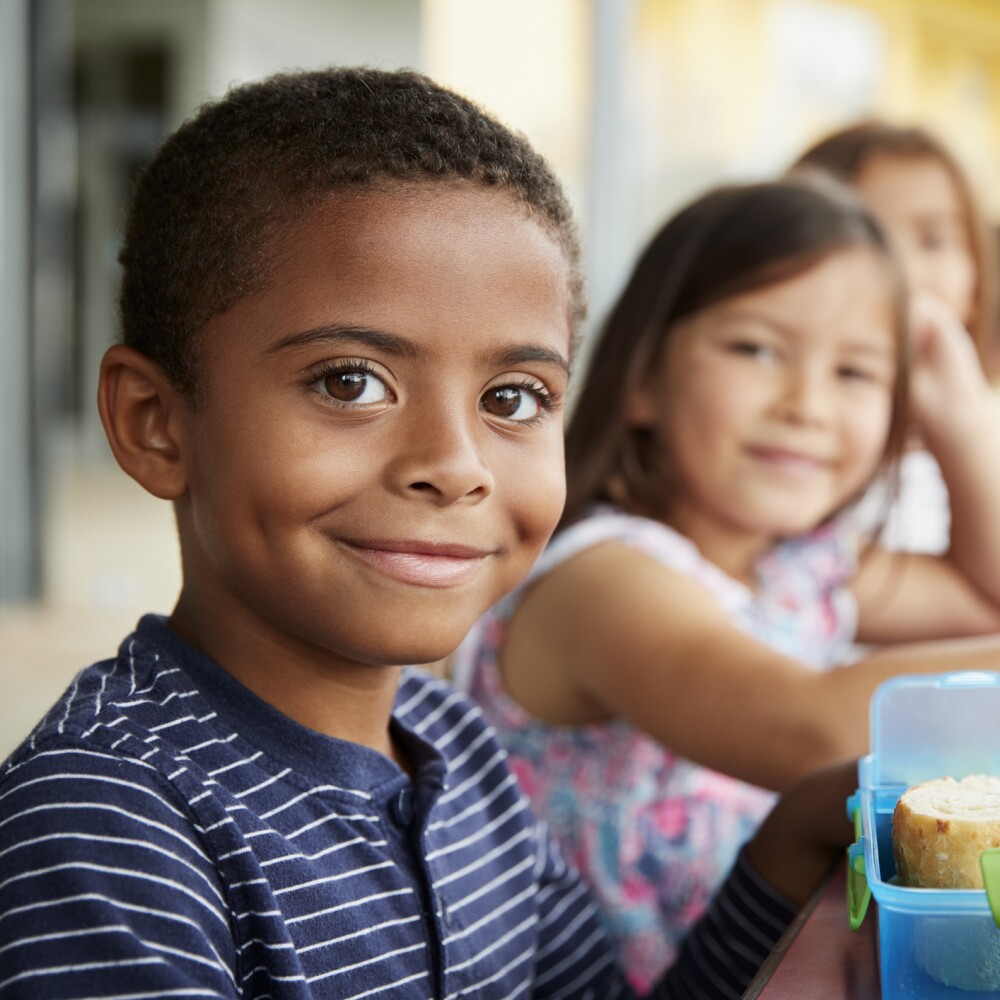 Diverse elementary students having lunch at school