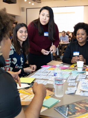 A group of parents gather around a table at an event. 