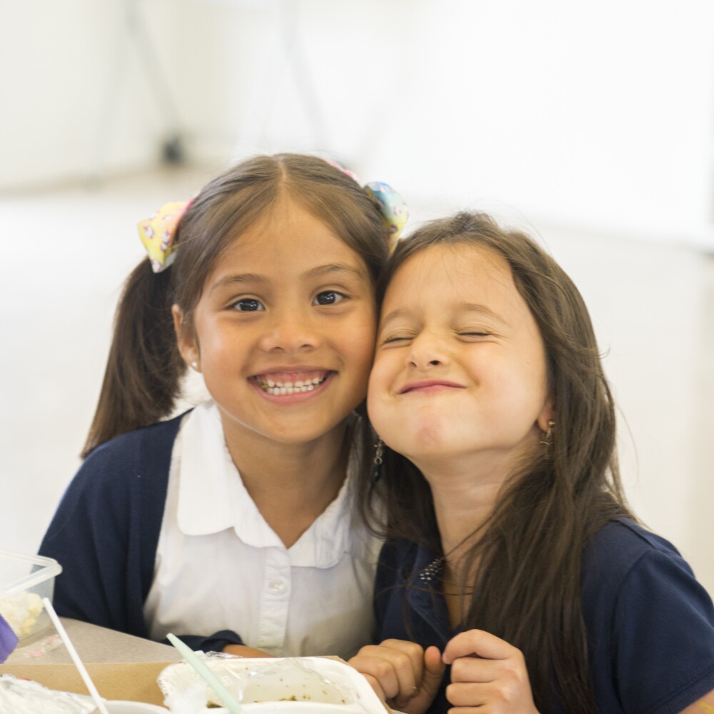 Two students smiling TLC Innovative Schools