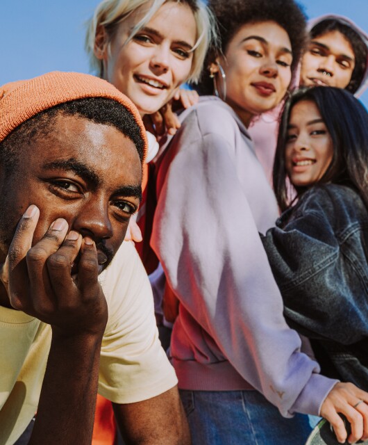 Multiracial group of young friends bonding outdoors