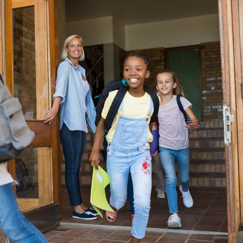 Children running outside school building