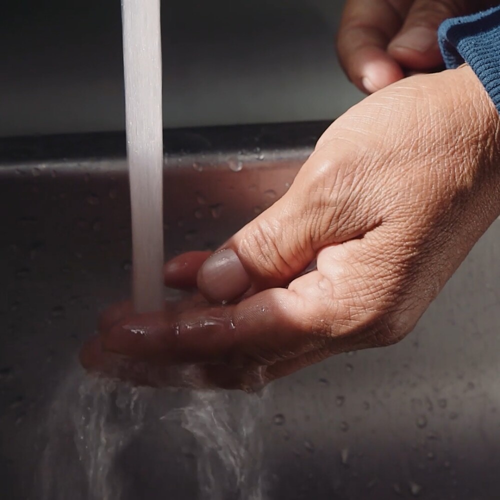 Navajo Water Project. Hand under tap
