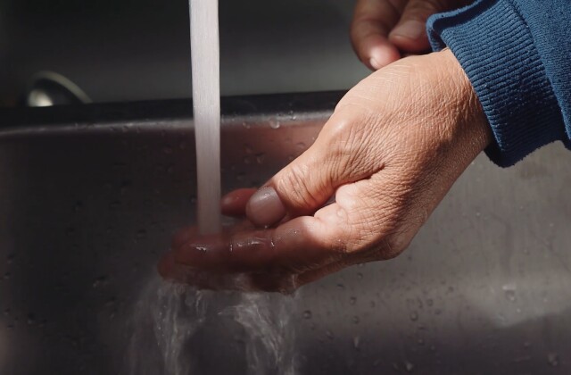 Navajo Water Project. Hand under tap