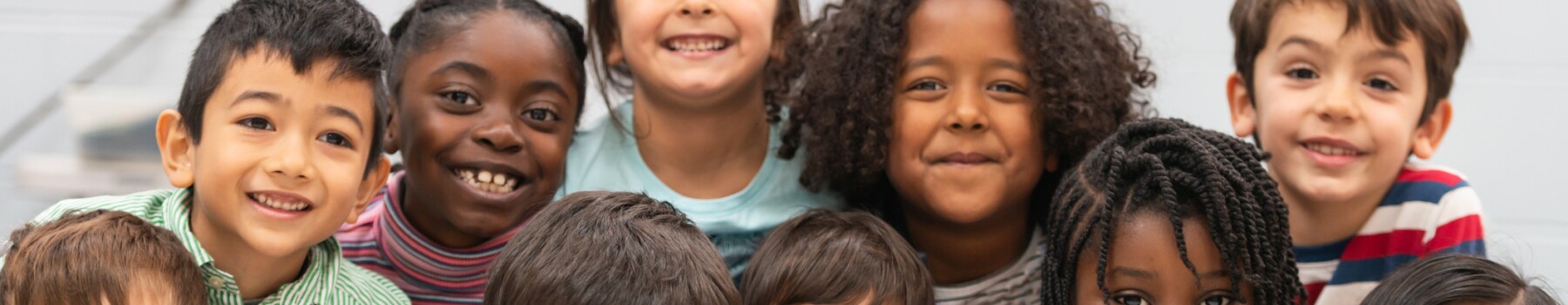 Diverse elementary students smiling for program page