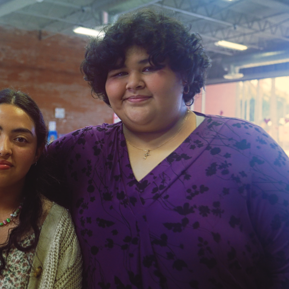WeThrive students Cisa Salazer  and Chelsea Vasquez smile and embrace at the Hawthorne Teen Center in Hawthorne, California.